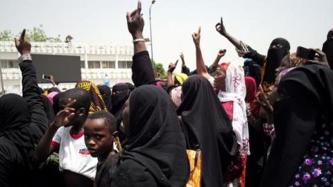 Women at a protest on April 5 gesturing to rally against the government and international forces' failure to tackle rising violence in Mali