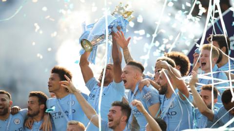 Man City's Vincent Kompany lifts the Premier League trophy