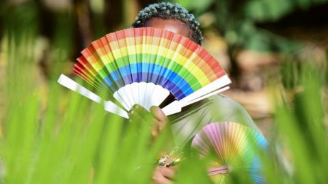 Woman has a rainbow fan in Uganda