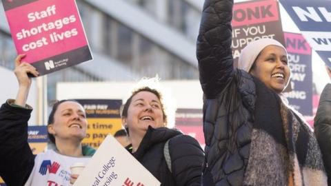 Picket line supporters with placards