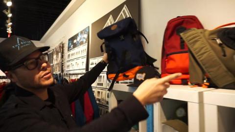 Man shows off backpacks