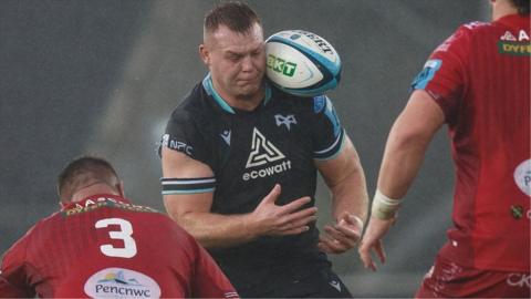 Dewi Lake of Ospreys struggles for control of the ball against Scarlets