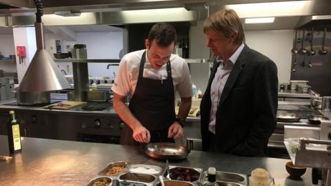 A chef and his boss in the kitchen