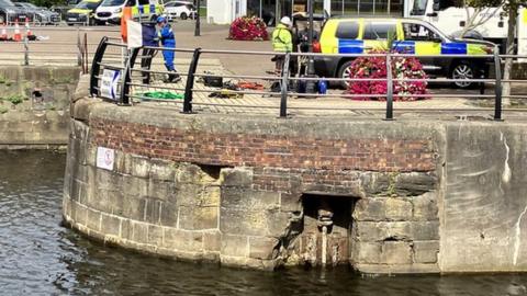 Emergency vehicles and workers near the National Waterfront Museum at Swansea Marina