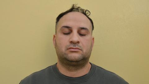 Custody image of Tarek Namouz, 43, pictured with his eyes closed.