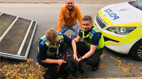 Neil, police officers and Ruby the dog