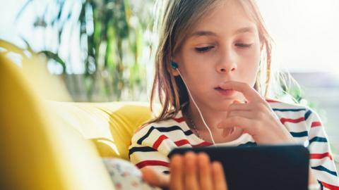 Child and mobile device (stock image)