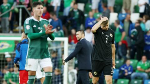 Northern Ireland players dejected after losing on Monday evening