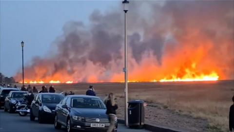 Flames spread across marshland