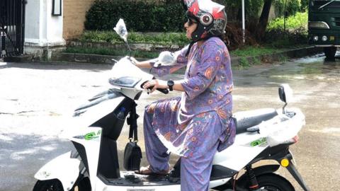 Female student on moped