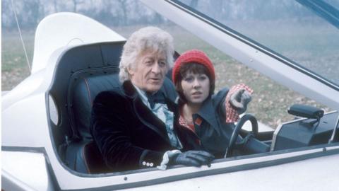 Jon Pertwee as The Doctor with Elisabeth Sladen as Sarah Jane Smith aboard the Whomobile in the 'Dr Who' adventure 'The Planet of the Spiders' 1974