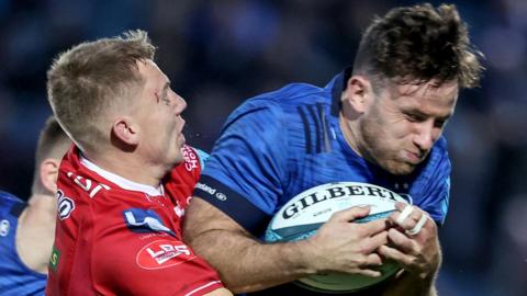 Scarlets back Johnny McNicholl tackles Leinster's Hugo Keenan