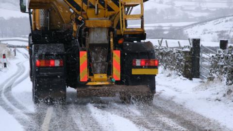 A gritter spreading salt on a road
