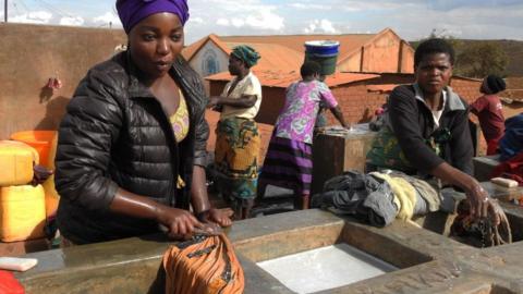 Refugees wash their clothes on June 20, 2018, on World Refugee Day at Dzaleka Refugee Camp in the Dowa district, central region of Malawi