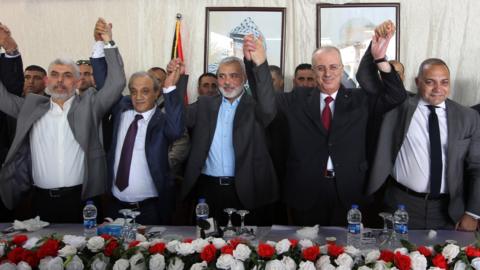 From L to R: Hamas Gaza chief Yahya Sinwar, Director of Palestinian General Intelligence in the West Bank Majid Faraj, Hamas political leader Ismail Haniya, Palestinian Prime Minister Rami Hamdallah and an Egyptian mediator hold hands during a meeting in Gaza City (2 October 2017)