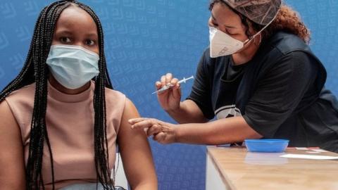 A woman receives a dose of the Pfizer-BioNTech vaccine against Covid-19 in Sandton, Johannesburg, on 15 December 2021