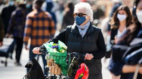 A person wears a face mask while shopping at the Union Square Greenmarket