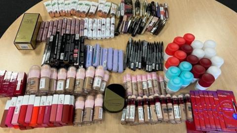 The stolen make-up laid out on a table