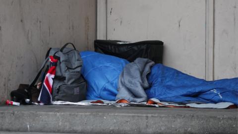 Image of homeless person sleeping rough in a doorway