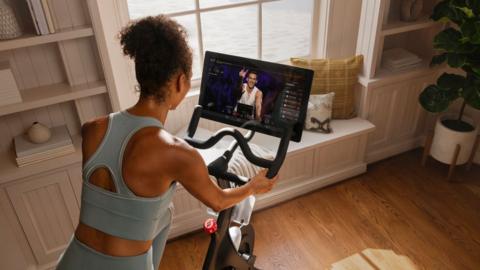 Peloton user following a live class from home