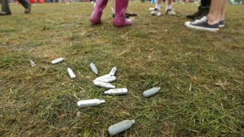 Discarded laughing gas canisters at a music festival