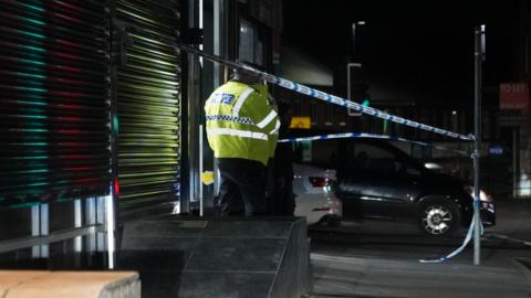 Police outside a barber shop