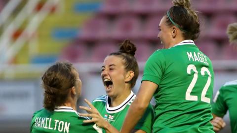 Rebecca McKenna is embraced by her Northern Ireland team-mates Caragh Hamilton and Abbie Magee after hitting the winning in Luxembourg