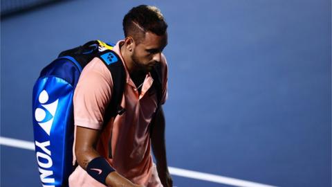 Nick Kyrgios with his head bowed as he walks off court after retiring hurt at the Mexican Open