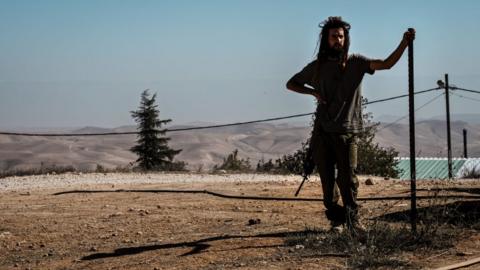 An armed Israeli settler pictured in November