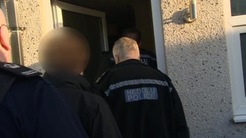 Police and immigration officials raid a property in Risca, Newport, in connection with people smuggling