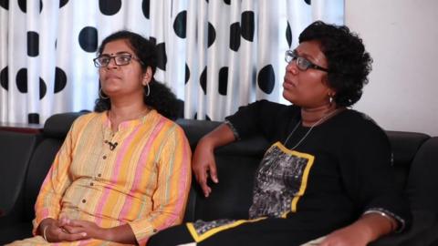 Kanakadurga and Bindu Ammini sit on sofa in screenshot