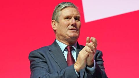 Labour party leader, Sir Keir Starmer applauds speakers during the final day of the Labour Party conference on October 11