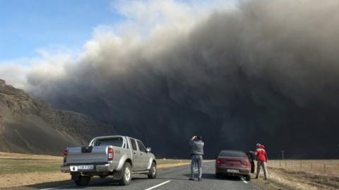 Motorists take pictures of Iceland's Eyjafjallajokull volcano in 2010