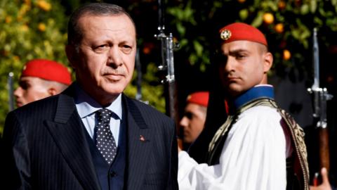 Turkish President Recep Tayyip Erdogan reviews the Greek Presidential Guard before a meeting in Athens