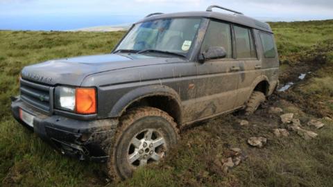 Land Rover stuck in a rut on heathland