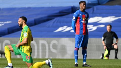 Wilfried Zaha stands at kick-off