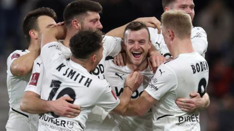 Boreham Wood's players celebrate scoring against Bournemouth in the FA Cup