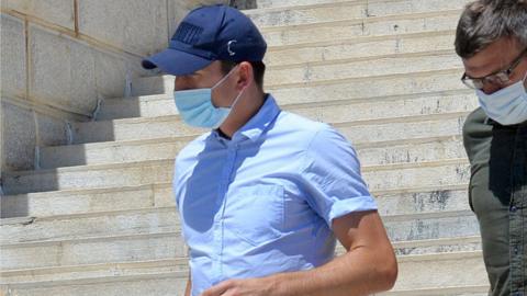 Harry Maguire (C, blue cap) leaves a court building on the island of Syros, Greece, 22 August 2020
