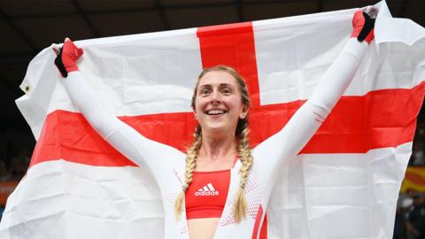 Laura Kenny holds up an England flag