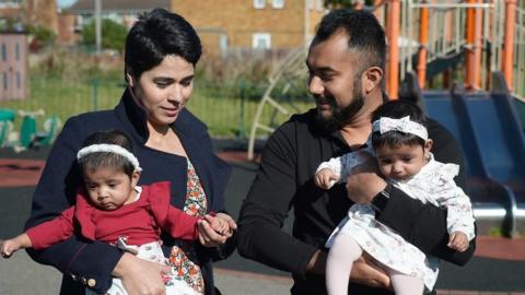 Sultana Ashiq and her partner holding their twins