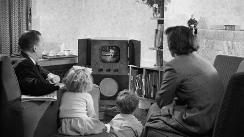 Family watching a television