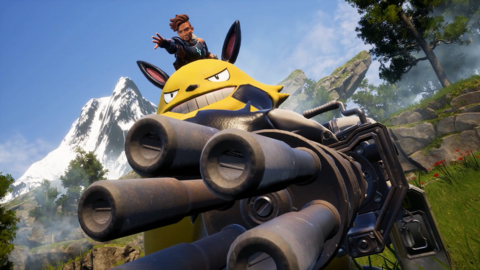 A character with brown locs swept to the side emerges from the dome of a tank like vehicle. The dome is bright yellow and sports the menacing face of a creature with a wide, toothy smile and black ears. The tank itself has five large cannon pointing out-of-shot, trained on an unseen target. The surrounding environment includes a snow-topped mountain and rocky, tree-lined terrain.