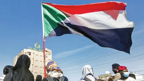 Sudanese flag carried in street in Omdurman (file photo)