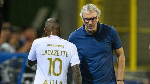 Ex-Lyon manager Laurent Blanc shakes hands with striker Alaxandre Lacazette