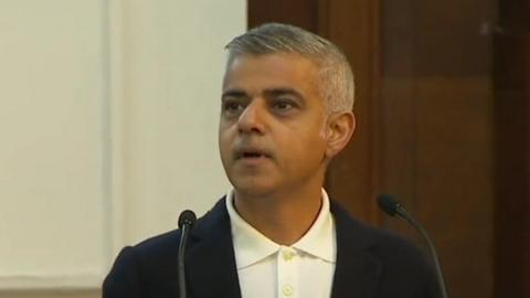 Sadiq looks shocked as he is interrupted by protesters