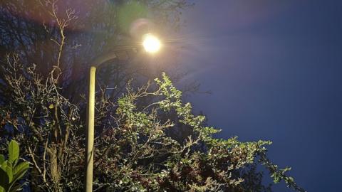 A lit street light