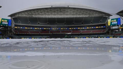 A general view of the Adelaide Oval as rain falls on the covers