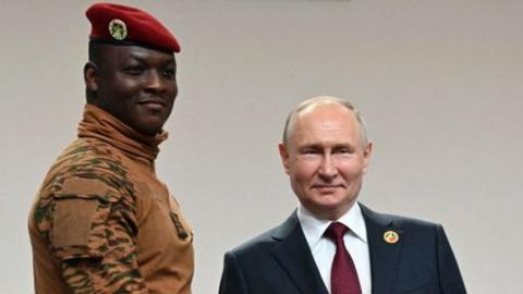 This pool image distributed by Sputnik agency shows Russian President Vladimir Putin greeting Burkina Faso's junta leader Captain Ibrahim Traore during a welcoming ceremony at the second Russia-Africa summit in Saint Petersburg on July 27, 2023