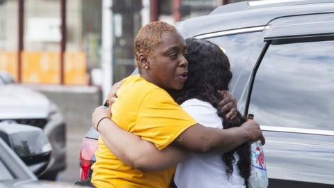 Image shows two women hugging