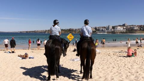 Two police officers on horses on Sydney's Bondi Beach